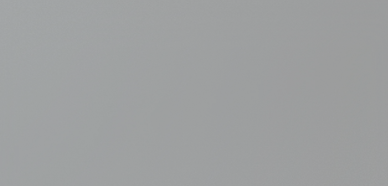 A spiraled notebook with a blue cover lies closed on a dark surface.